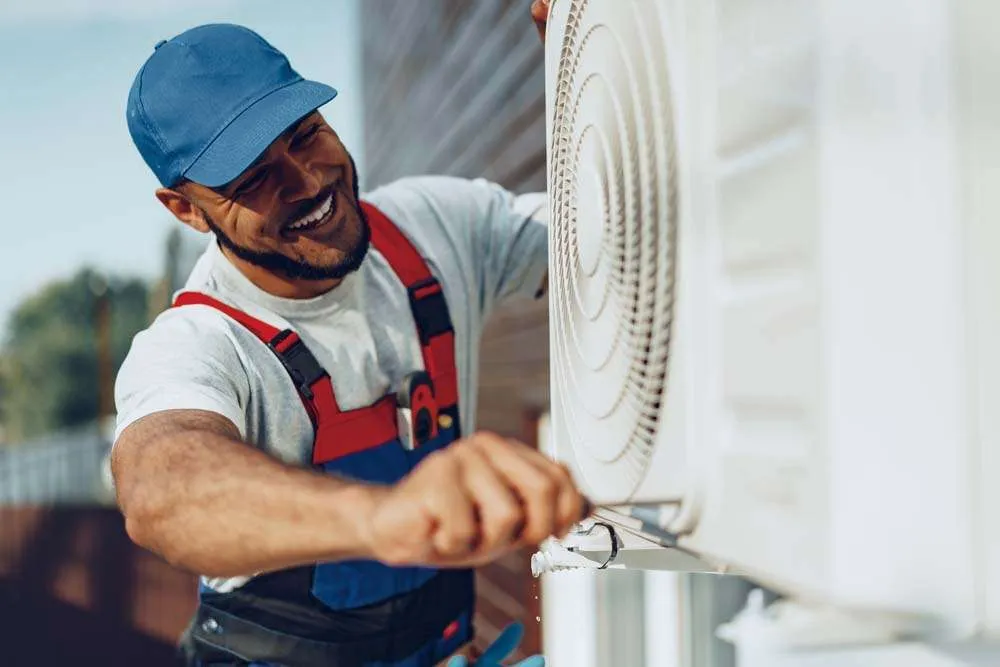 man repairing an air conditioner